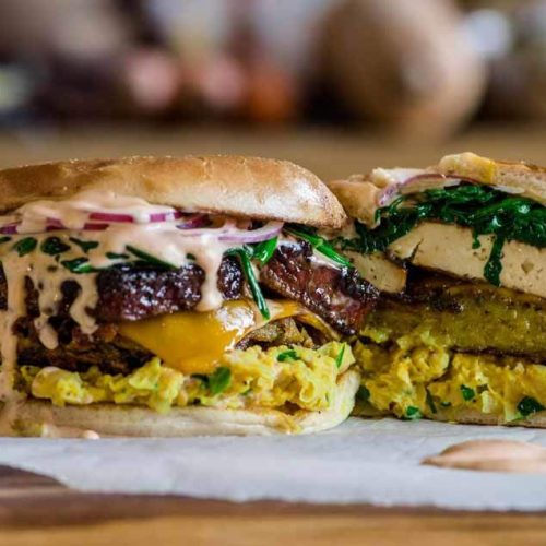vegan breakfast sandwich with smokey tofu bacon, hash, chickpea eggs